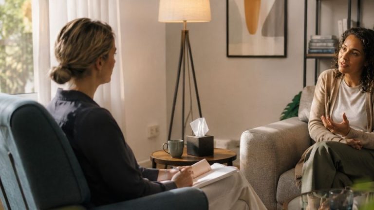 DBT vs. CBT Key Differences in Addiction Treatment hero image of a woman in therapy.