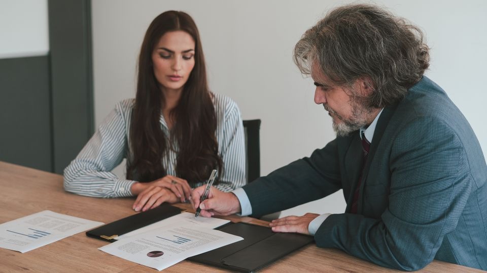 Employee reviewing medical leave paperwork with a human resources representative before starting treatment