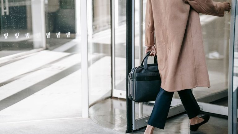 Woman arriving at an evening outpatient treatment session after work, showing you can work while in rehab