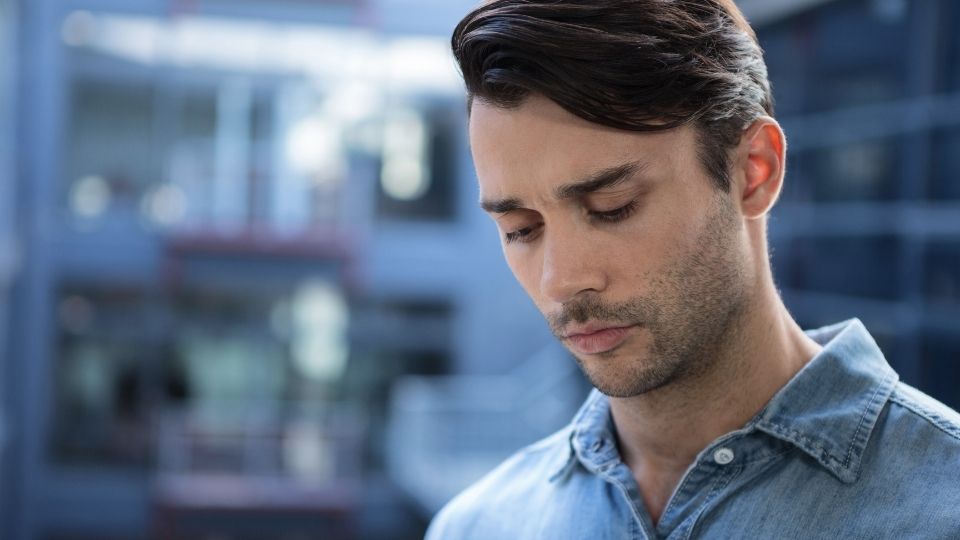 a man looks down while researching if benzos are opioids.