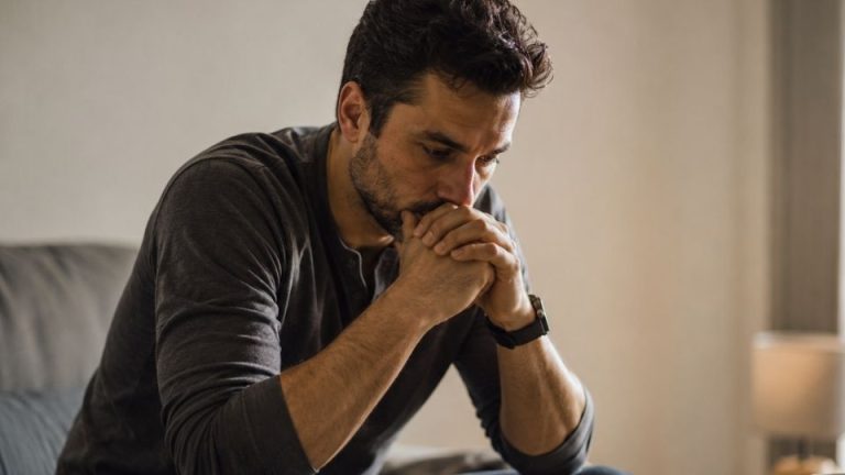 5 Questions To See if You Have A Drinking Problem hero image of a man considering if he has a problem.