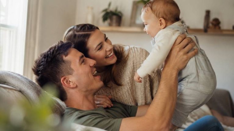 Is Addiction Hereditary hero image of a family sitting happily togther.