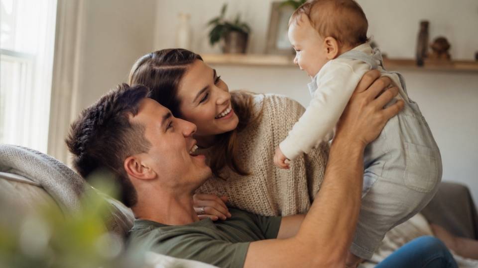 Is Addiction Hereditary hero image of a family sitting happily togther.