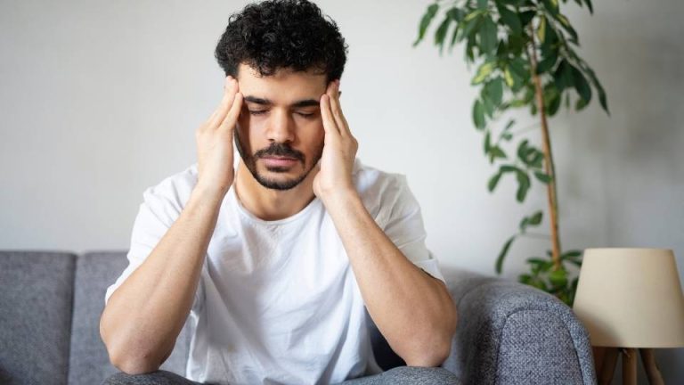 What Is the Success Rate of AA hero image of a man with a headache who is experiencing drug addiction.