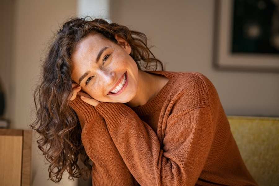 What is Brain Mapping Used for in Addiction Treatment A woman smiles after getting brain mapping during her treatment, giving her clues for what she needs to do to improve.