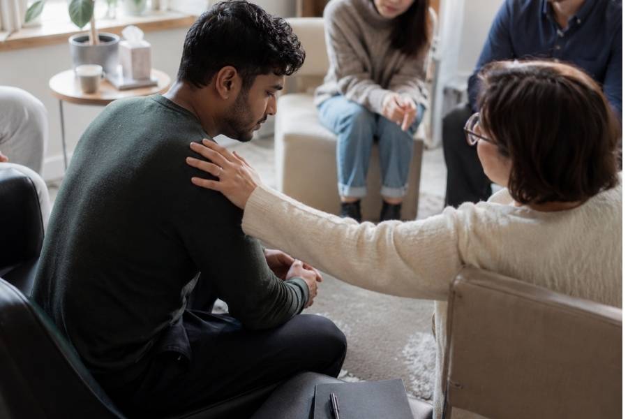 a man is supported during group therapy, one way trauma-informed care helps people at Simple Path Recovery.