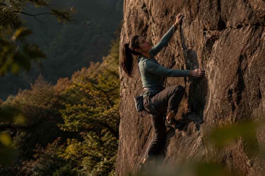 a woman enjoying rock climbing as part of adventure therapy.