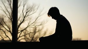 Quitting Alcohol Cold Turkey hero image of a man shown in shadow after quitting alcohol.