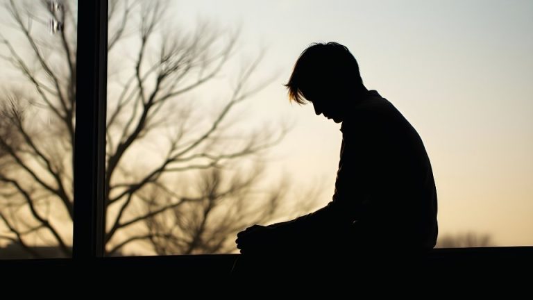Quitting Alcohol Cold Turkey hero image of a man shown in shadow after quitting alcohol.
