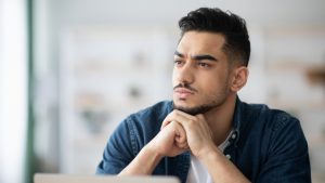 Is Partial Hospitalization Considered Inpatient Treatment hero image of a man thinking about the answer.