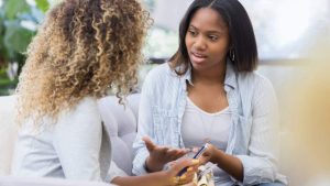 What Is a Partial Hospitalization Program (PHP) hero image of two women talking in therapy.