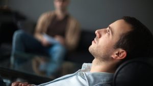 Who Is Eligible for PHP hero image of a man in individual therapy.